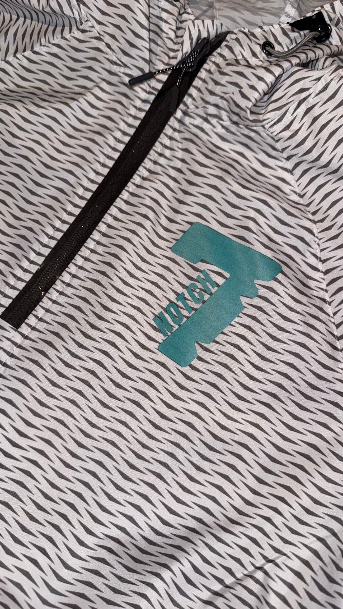 White pack hoodie with Teal Notch 7 logo