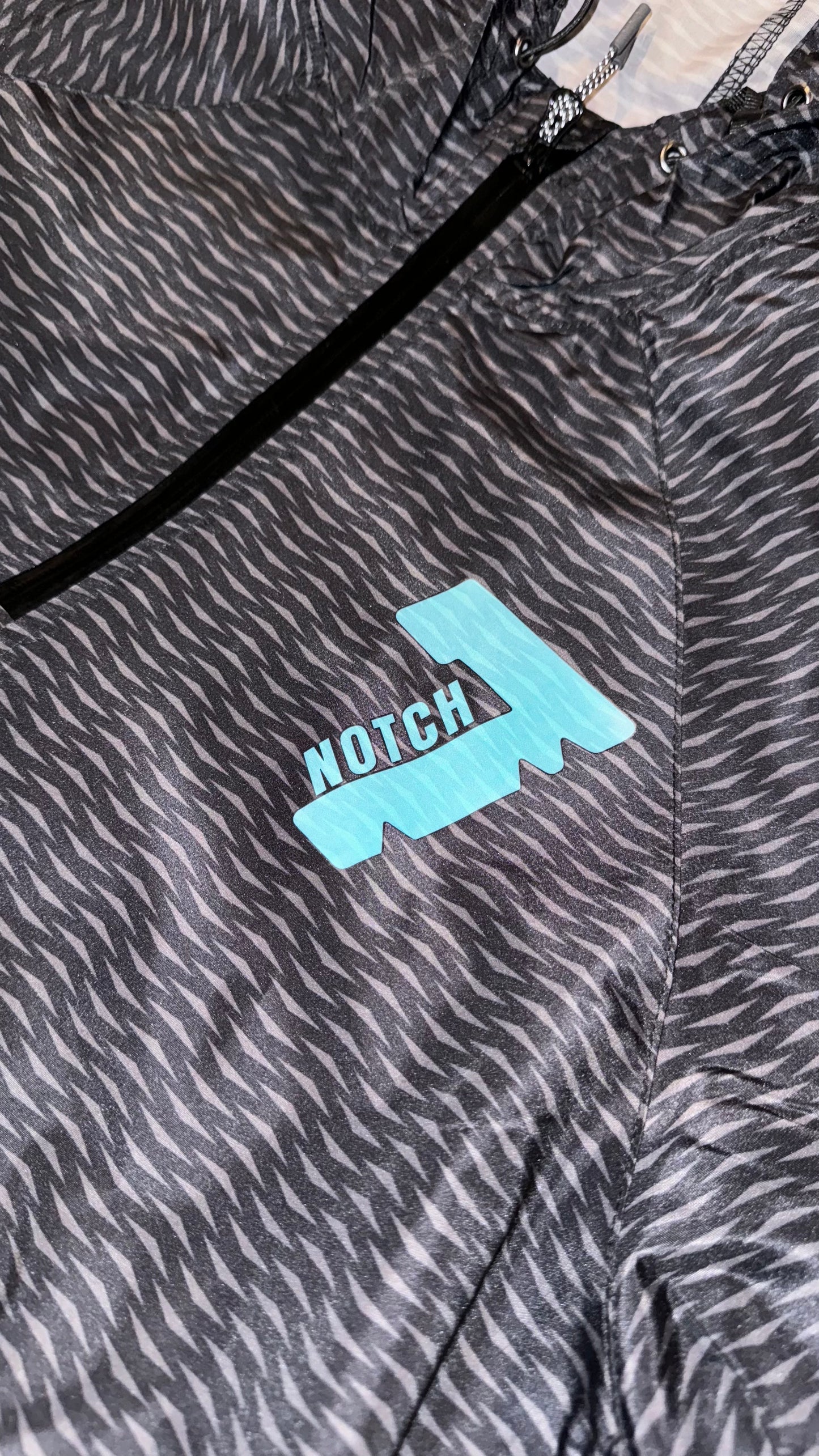 Black pack hoodie with Teal Notch 7 logo