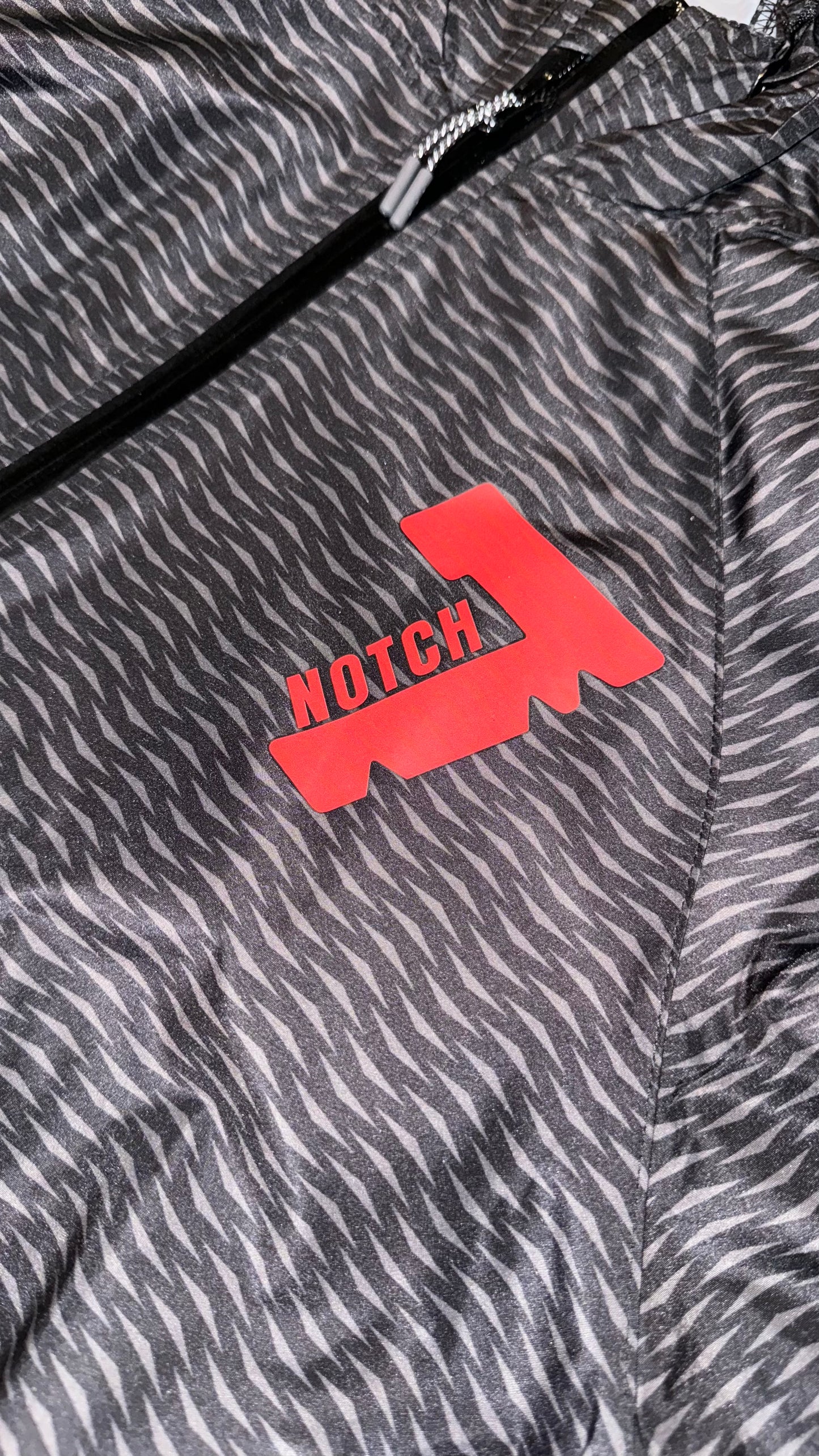 Black pack hoodie with red Notch 7 logo